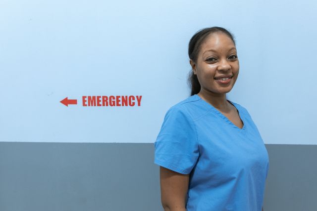 A Nurse Wearing a Scrub Suit Smiling